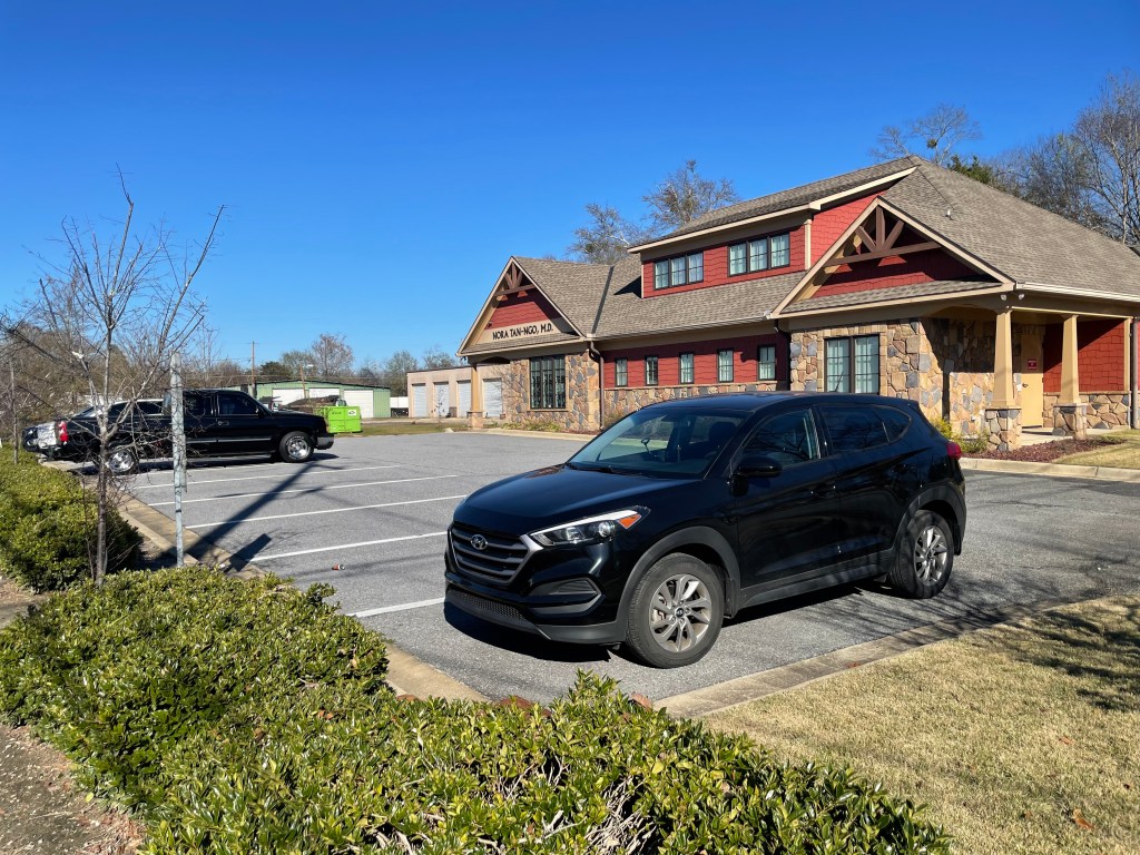 Cars waiting in office parking lot